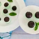Peppermint Cream Cheese Fat Bomb on small white plate and pedestal with mint leaves