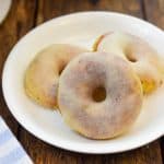 KETO BROWN BUTTER DONUTS 3 ON A WHITE PLATE WITH BLUE STRIPED TOWEL ON SIDE FIT TO SERVE