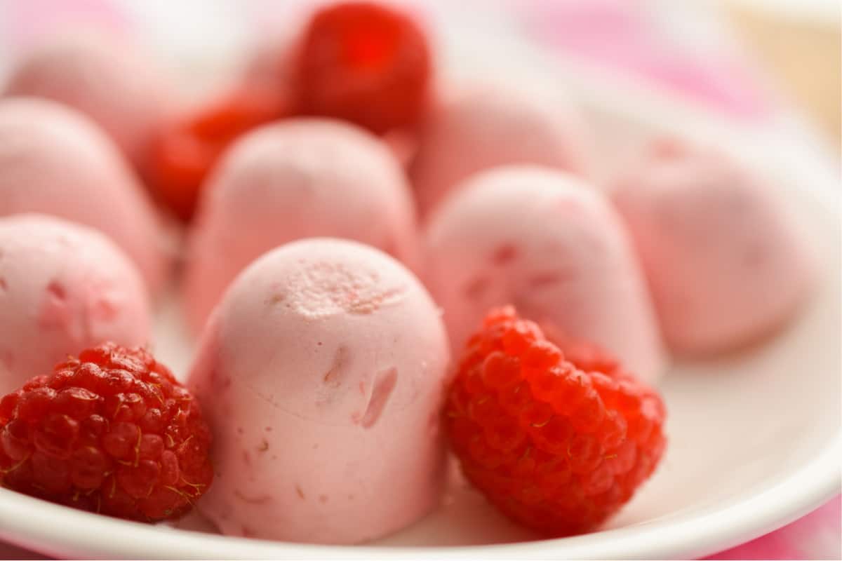 Keto Raspberry Cheesecake Fat Bombs with Raspberries Up Close