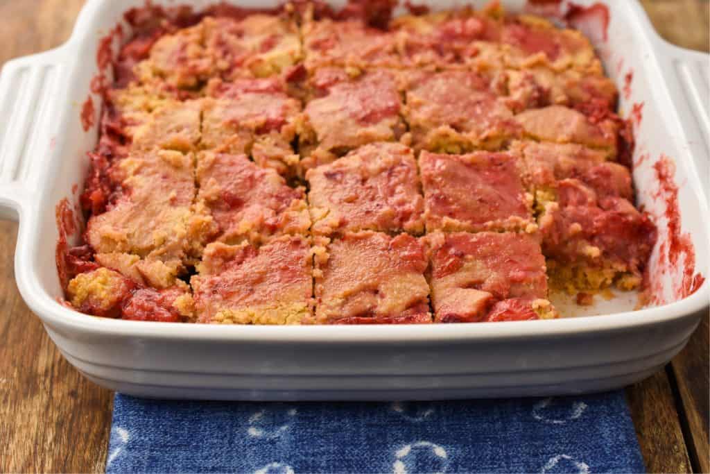 keto-friendly peanut butter jelly bars in a white baking pan
