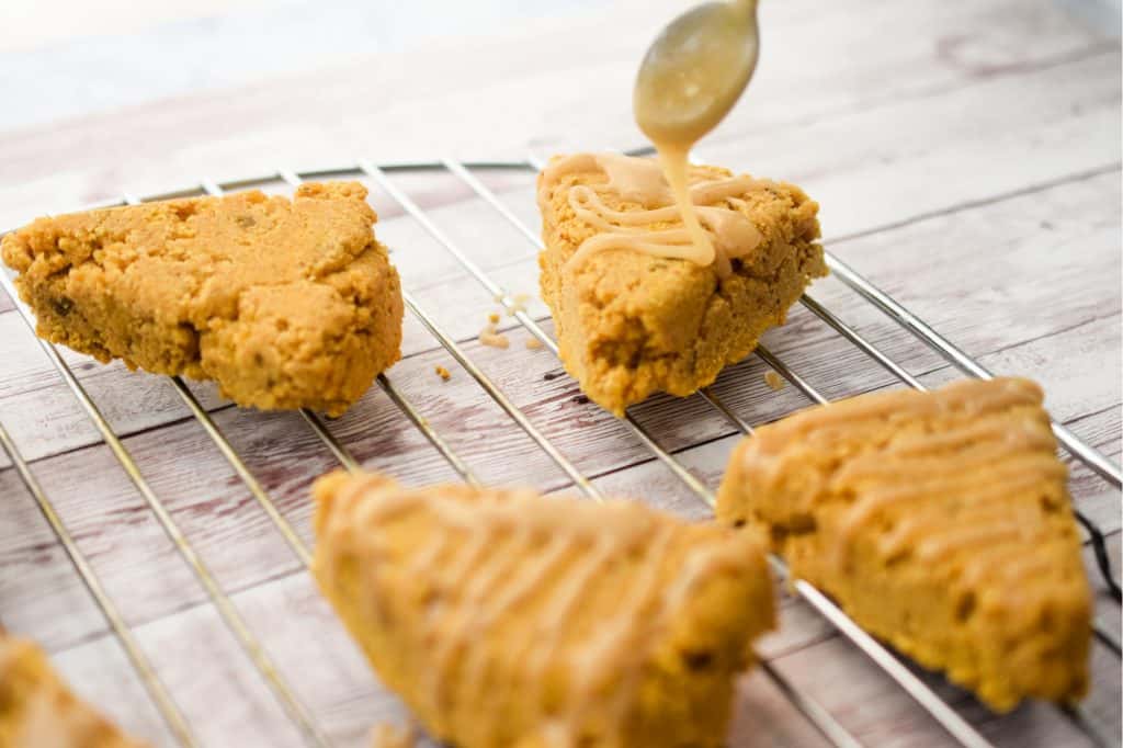 keto pumpkin spice scones being glazed