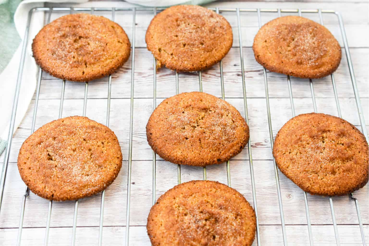 keto snickerdoodle cookies on a baking rack cooling