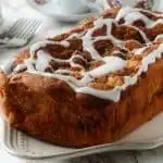 keto cinnamon swirl bread with vanilla icing close up on a white plate