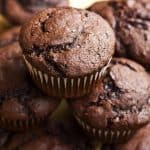 keto cream cheese chocolate muffins piled high close up