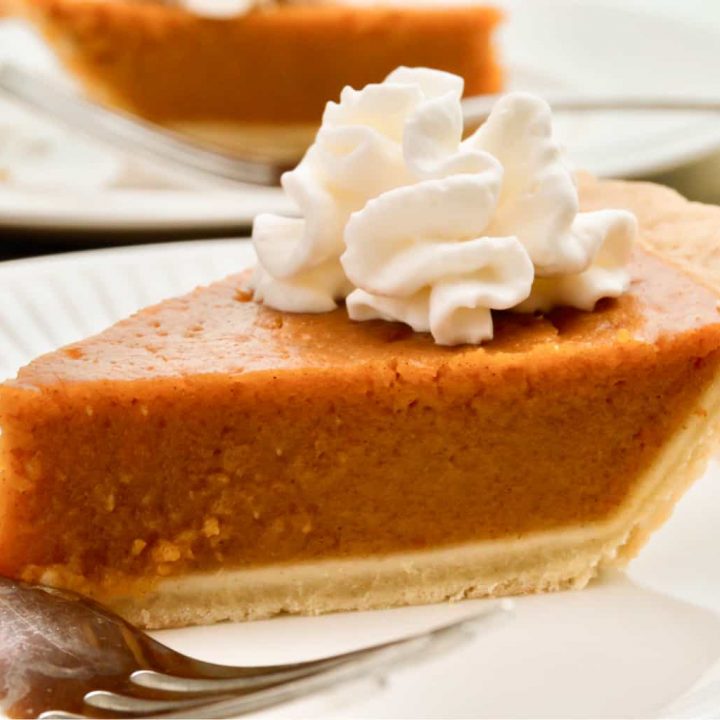 keto pumpkin pie sliced on a white plate