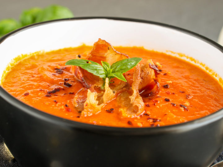 keto tomato bacon soup served in a small black and white bowl