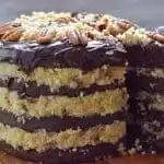 Four layer keto German chocolate layer cake being sliced