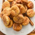 keto churro bites on a white cake stand