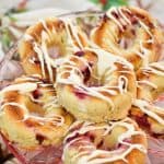 keto cranberry donuts stacked on a pink clear plate