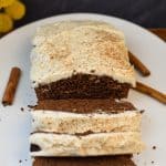 keto gingerbread loaf with cream cheese icing on a white platter