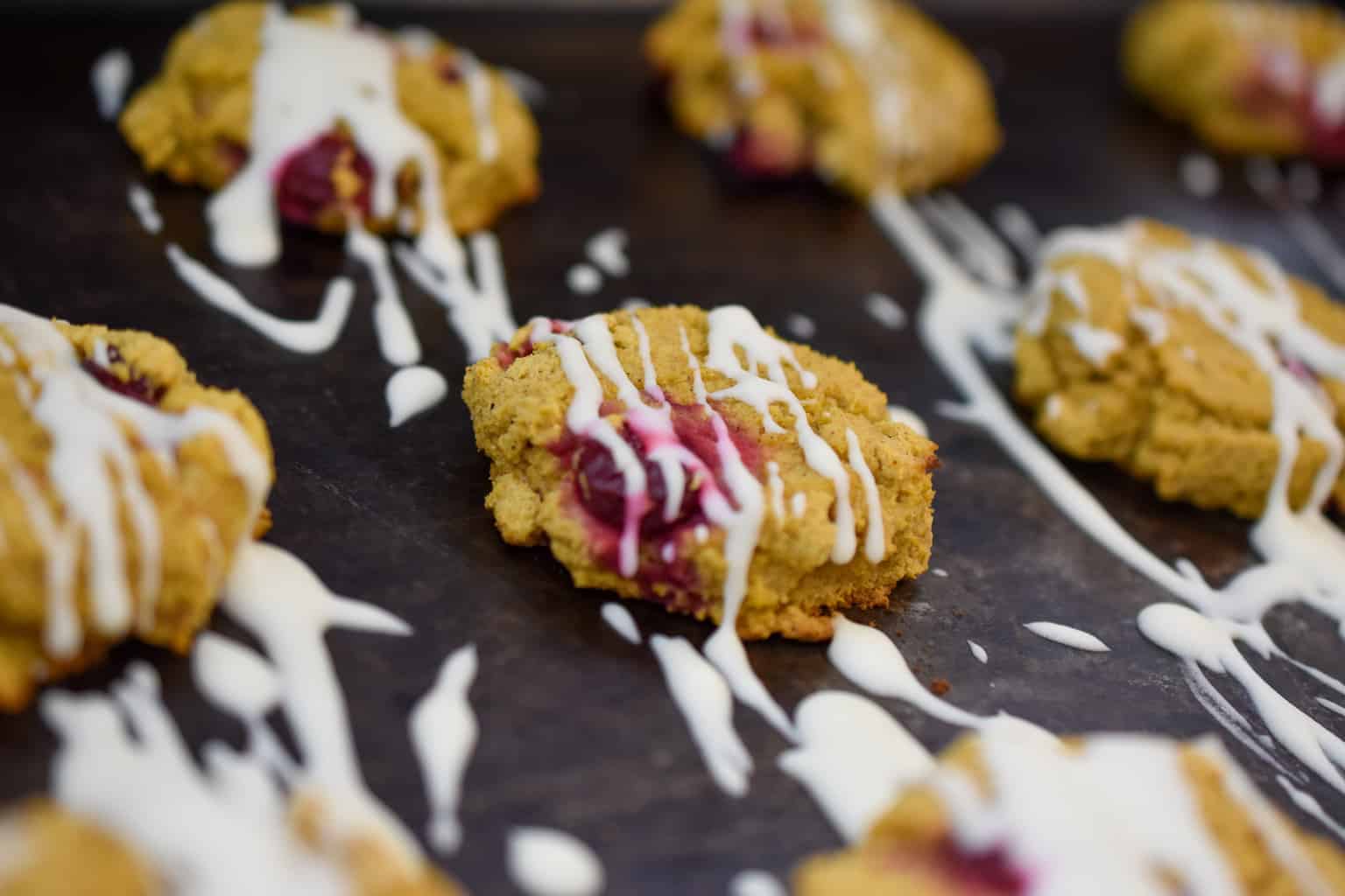 keto pumpkin cookies iced on a baking sheet