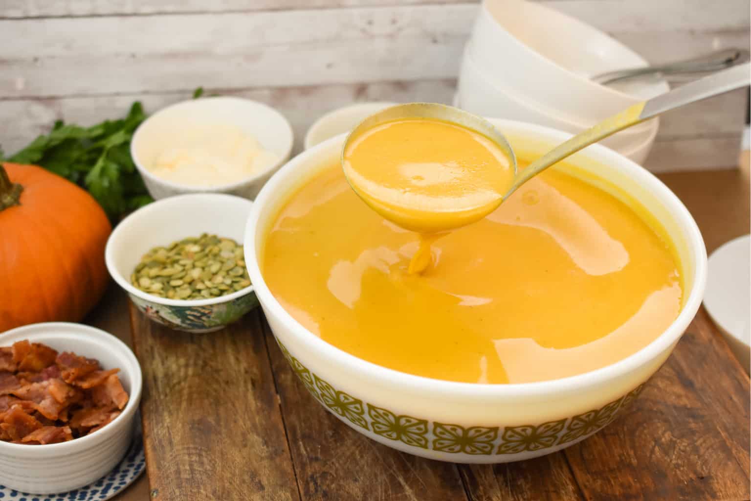 keto pumpkin soup with a large ladle