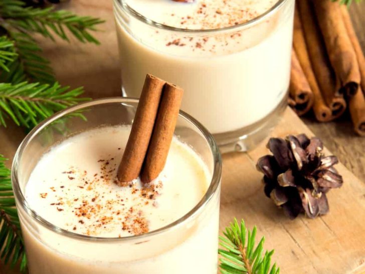 keto eggnog served in two clear glasses with cinnamon sticks