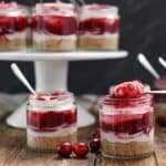 keto no-bake cranberry cheesecake on wood board with a dark backdrop