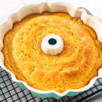 Cooling freshly baked a keto sour cream pound cake on a cooling kitchen rack.
