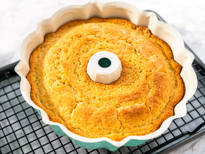 Cooling freshly baked a keto sour cream pound cake on a cooling kitchen rack.