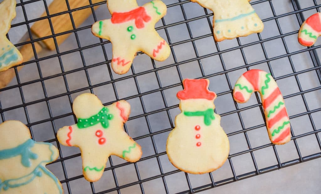 Keto Rolled Sugar Cookies decorated with icing on cooling rack