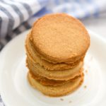 Keto coconut flour shortbread cookies stacked on a white plate
