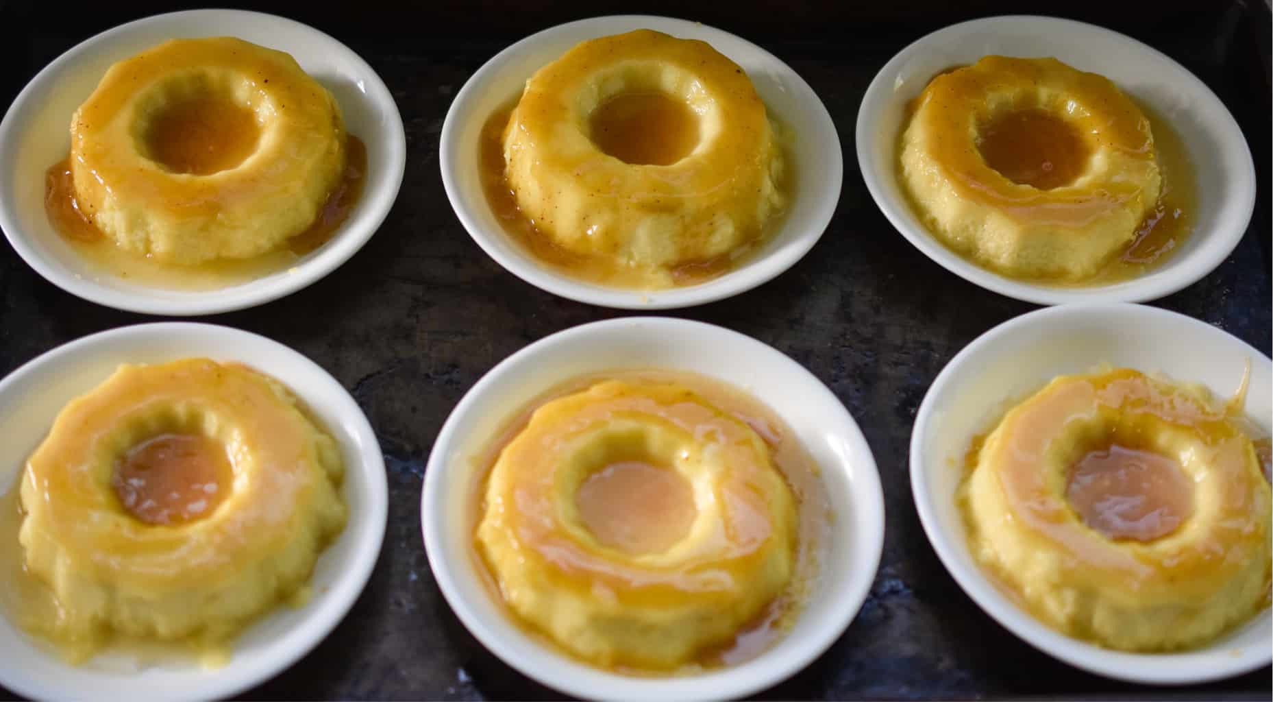 Six keto Cuban flans on a cookie sheet ready to serve