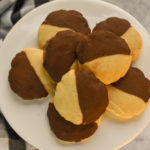 keto black and white cookies stacked on a white stand