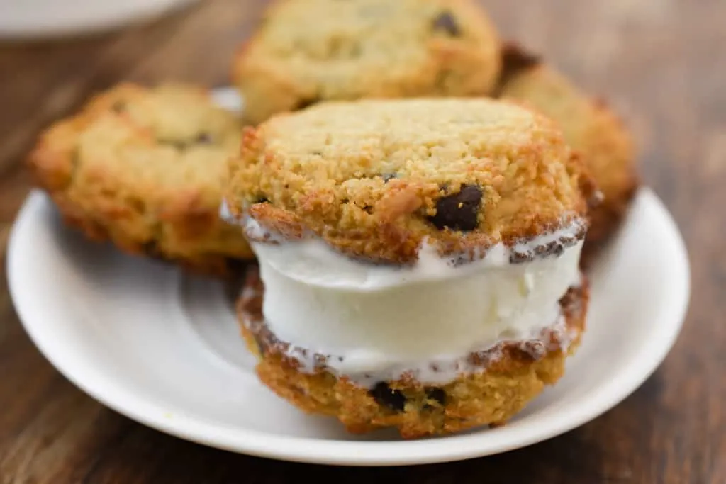 keto brown butter chocolate chip cookie ice cream sandwiches on a white plate fit to serve