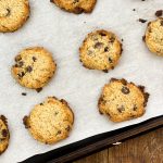 keto brown butter chocolate chip cookies on a parchment paper lined cookie sheet fit to serve