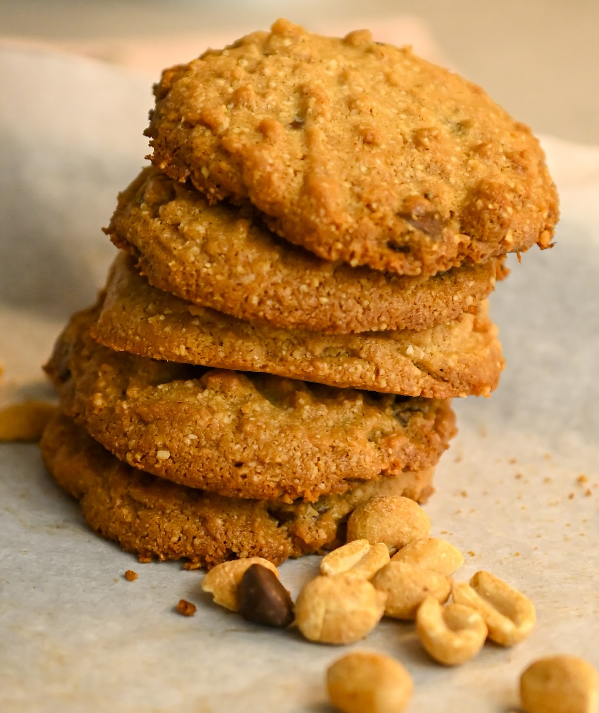 tacked keto peanut butter chocolate chip cookies on parchment paper