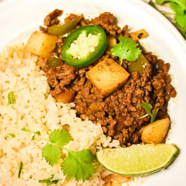 keto Mexican Picadillo served with cauliflower rice on a white plate