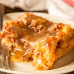 Keto bread pudding with butter rum sauce served on a small white plate