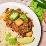 keto mexican picadillo served cauliflower rice on plate with turnip jalapeno and cilantro in background
