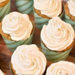 keto carrot cake cupcakes on a wood cake stand