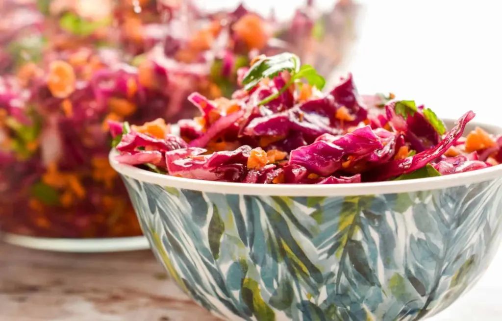 keto red cabbage slaw served in a green and yellow small dish