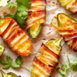 keto bacon jalapeño poppers on a piece of parchment paper