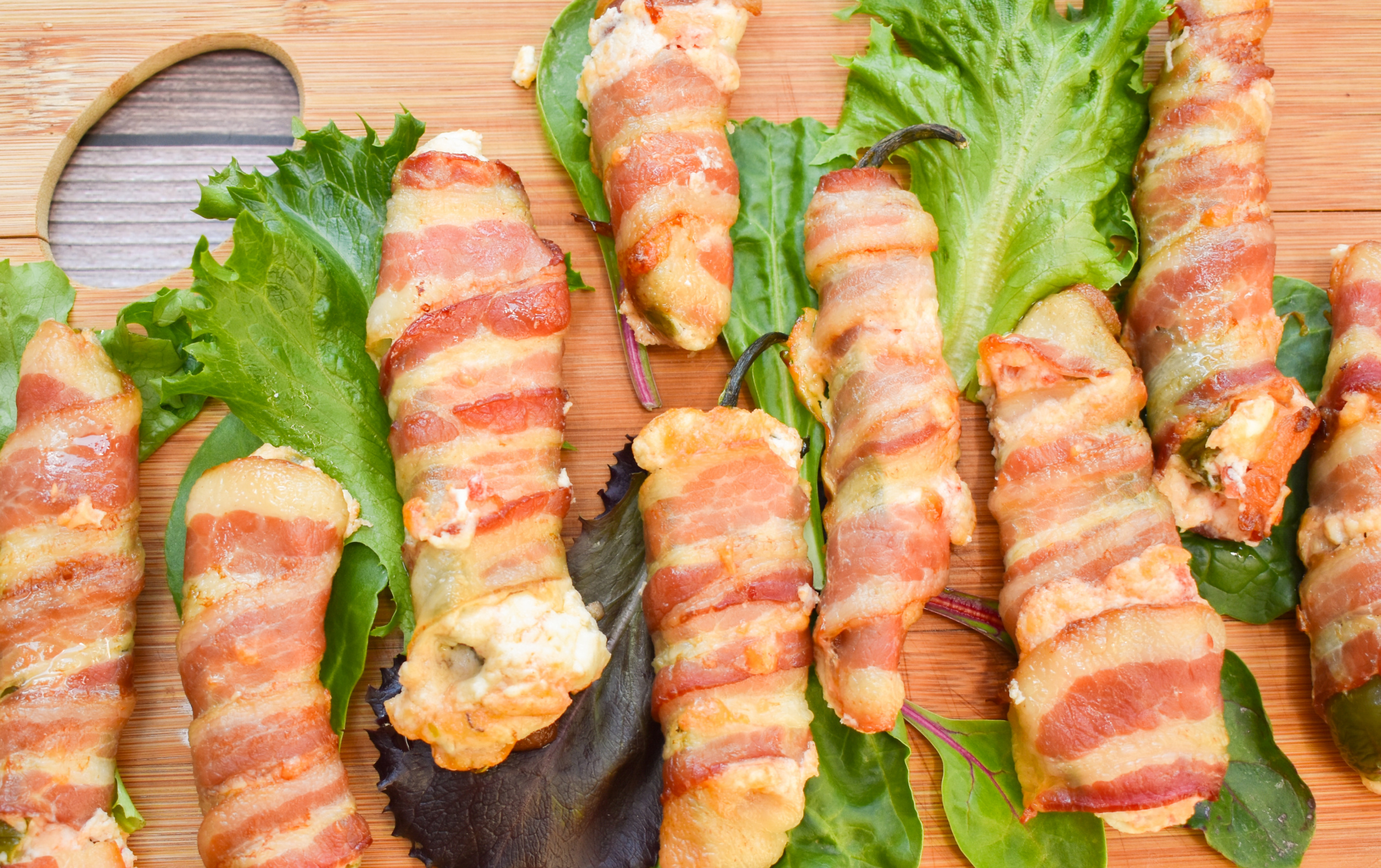 keto bacon jalapeño poppers on a wood board