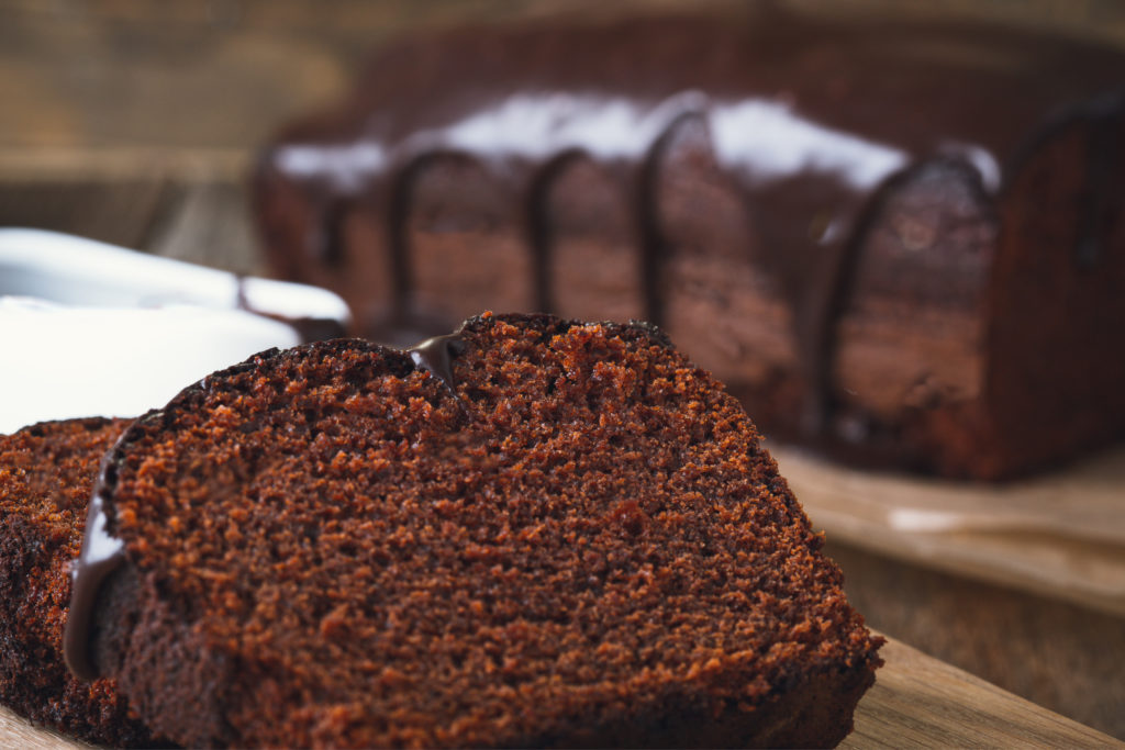 keto chocolate sour cream cake cake on wooden cutting board