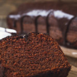 keto chocolate sour cream cake cake on wooden cutting board