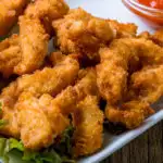 Keto Chicken tenders served on a white rectangle plate