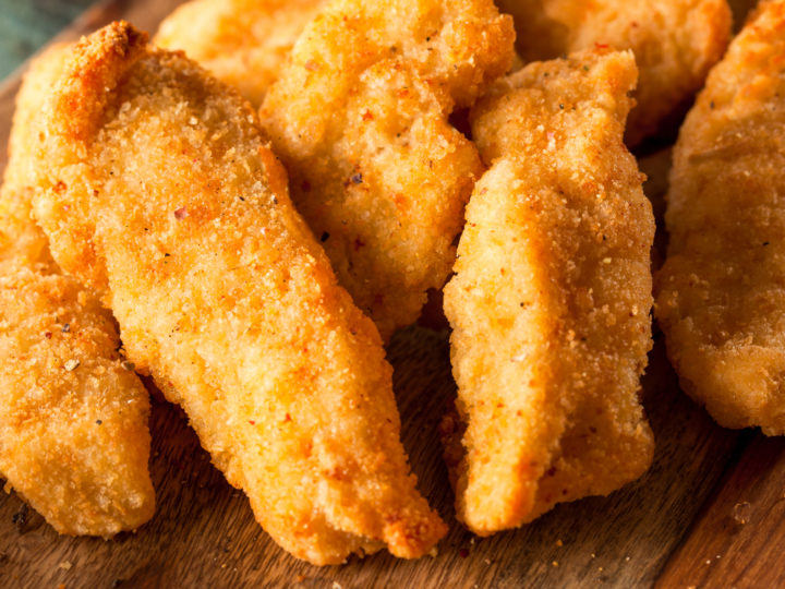 Keto chicken tenders served on a wooden board