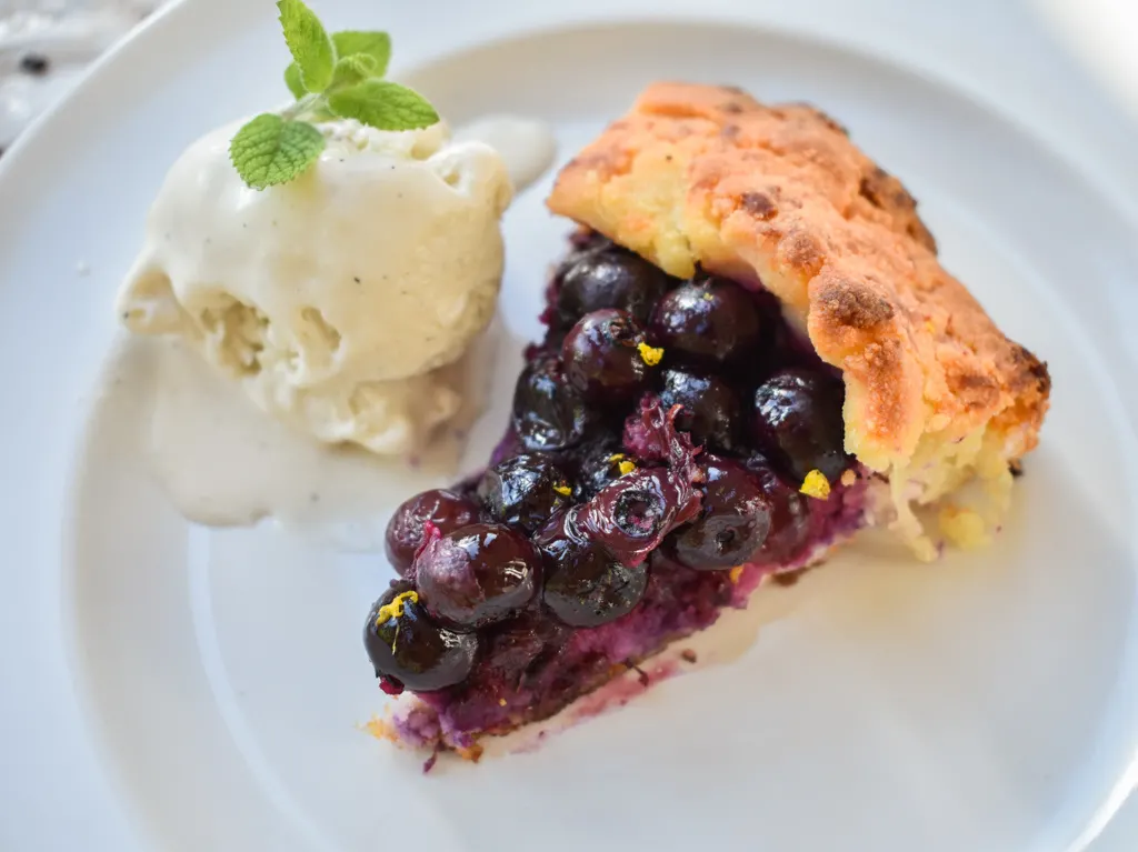 keto friendly blueberry galette with a scoop of vanilla ice cream