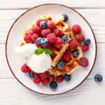 keto waffles served with blueberries and an ice cream scoop as dessert