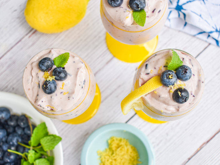 keto blueberry cheesecake mousse with dish of lemon zest and bowl of blueberries and lemon on the side