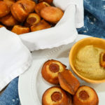 keto corn dog minis in a basket and on a white plate with a side of mustard