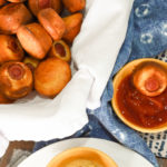 keto corn dogs in a white napkin lined basket