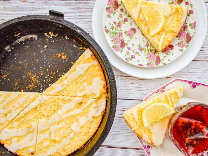 keto lemon ricotta scones in cast iron skillet with more scones on pink and white plates on the right
