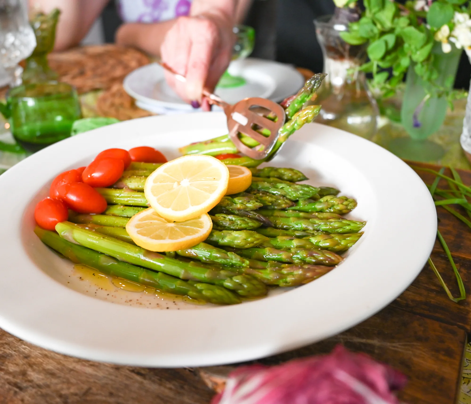 low carb asparagus salad being served with copper salad tongs