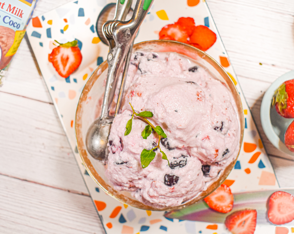 5 minute keto berry ice cream in gold bowl with scoop and topped