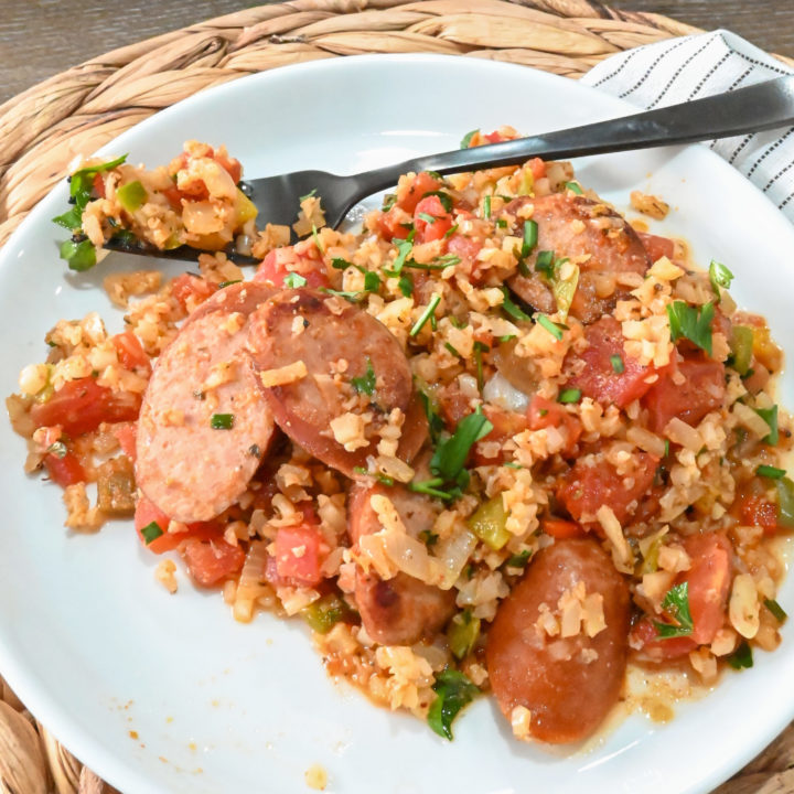 keto Spanish cauliflower rice and sausage served on a white plate