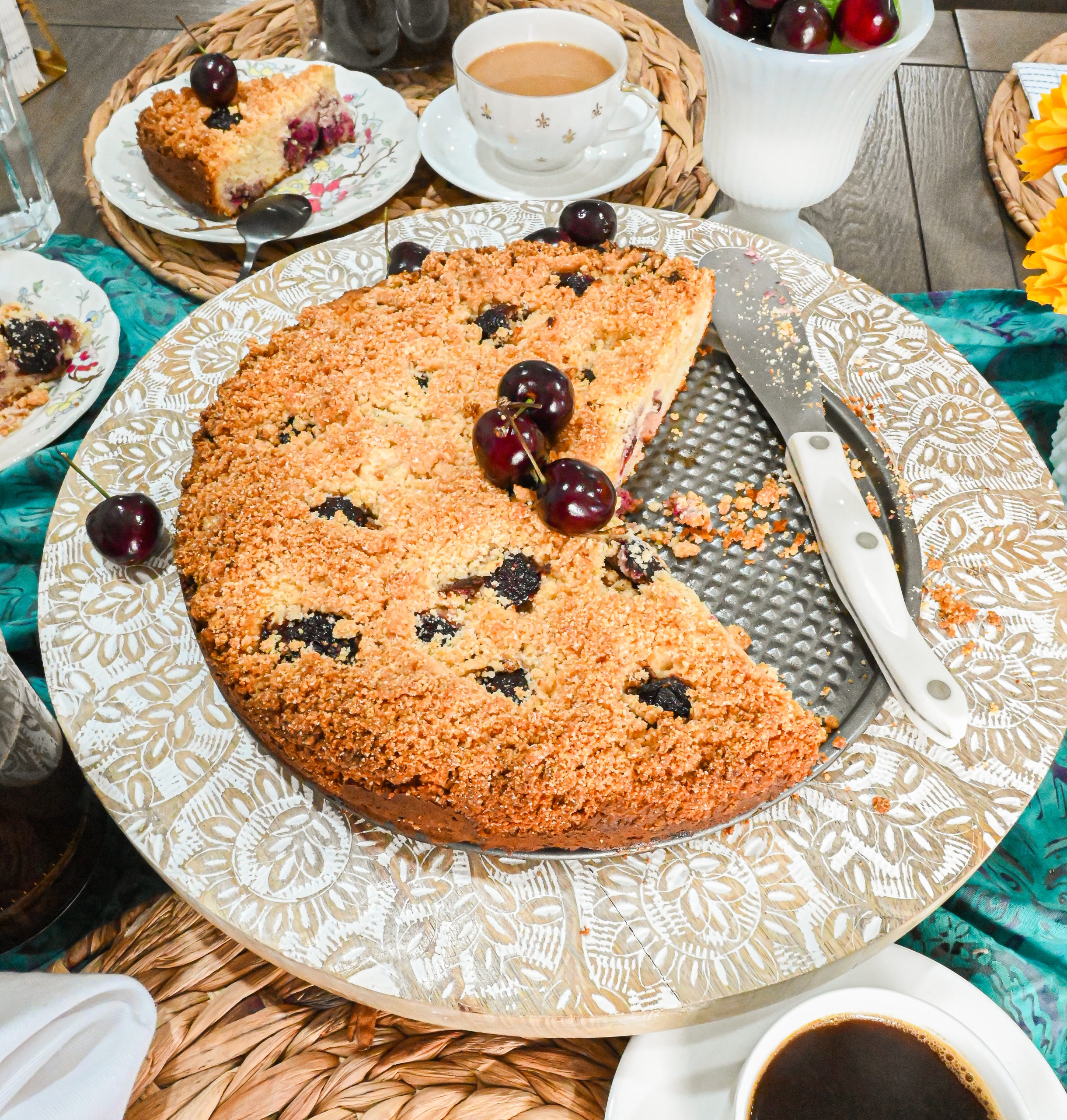 keto cherry coffee cake with slices cut out on stand