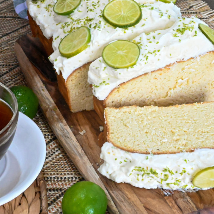 keto key lime pound cake sliced next to a cup of coffee