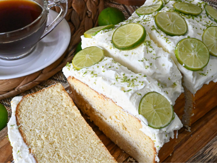 keto key lime pound cake sliced on a wood board